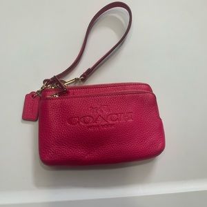 Woman’s real leather Coach wristlet.